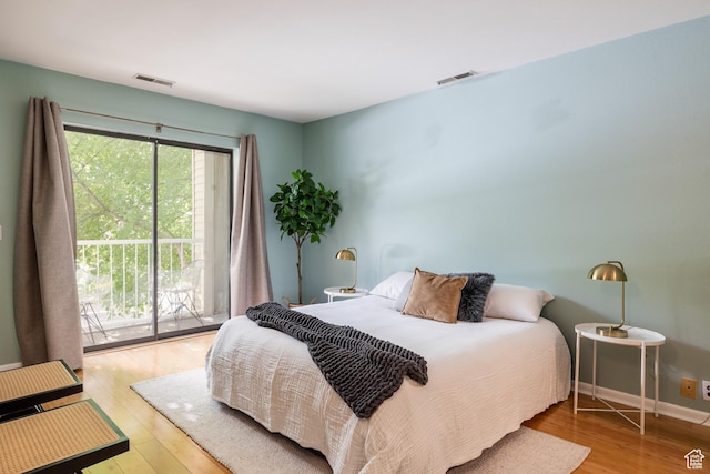 2660 E 3300 S Unit A-21, Salt Lake City, UT 84109 - bedroom with wood finished floors, access to exterior, and baseboards