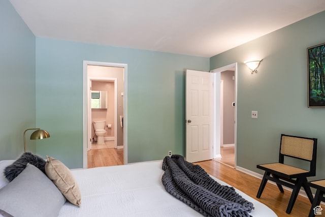 2660 E 3300 S Unit A-21, Salt Lake City, UT 84109 - bedroom with light wood-type flooring, baseboards, and ensuite bath