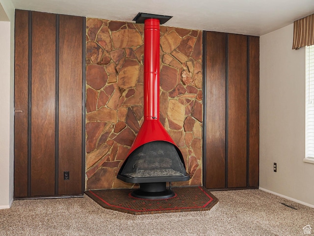 5747 S Sanford Dr, Murray, UT 84123 - detailed view of a wood stove, carpet flooring, and baseboards