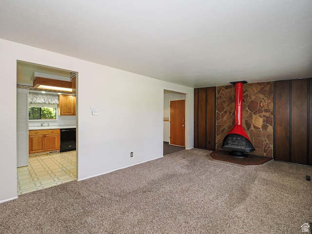 5747 S Sanford Dr, Murray, UT 84123 - unfurnished living room featuring a wood stove, a sink, light carpet, and baseboards