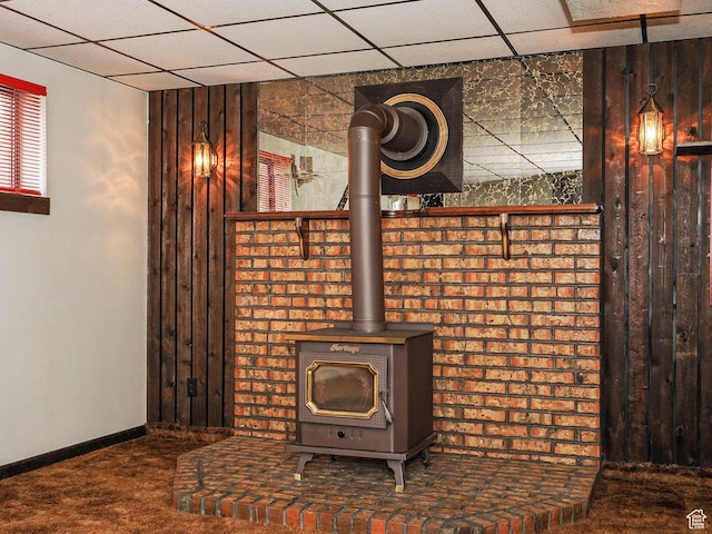 5747 S Sanford Dr, Murray, UT 84123 - detailed view of carpet, a paneled ceiling, a wood stove, and baseboards