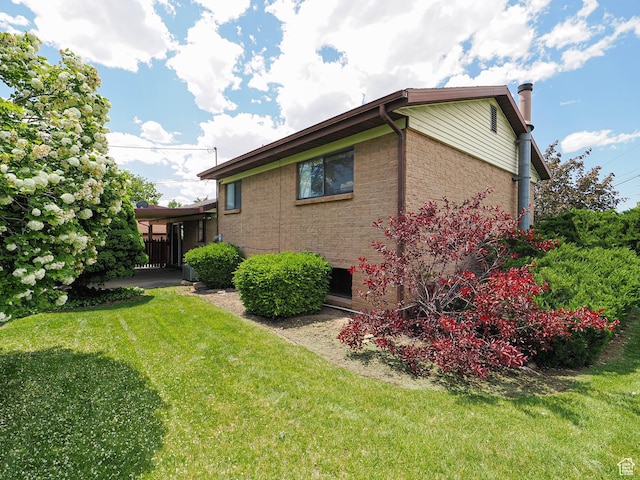 5747 S Sanford Dr, Murray, UT 84123 - view of side of property with a lawn, brick siding, and a chimney