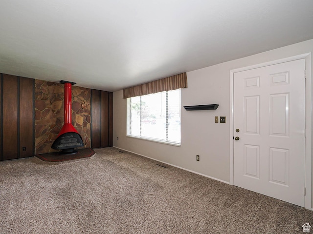 5747 S Sanford Dr, Murray, UT 84123 - unfurnished living room with a wood stove, carpet, and baseboards