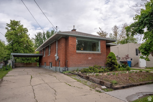 354 N 200 E, Logan, UT 84321 - bungalow-style house featuring brick siding, driveway, a chimney, and a detached carport