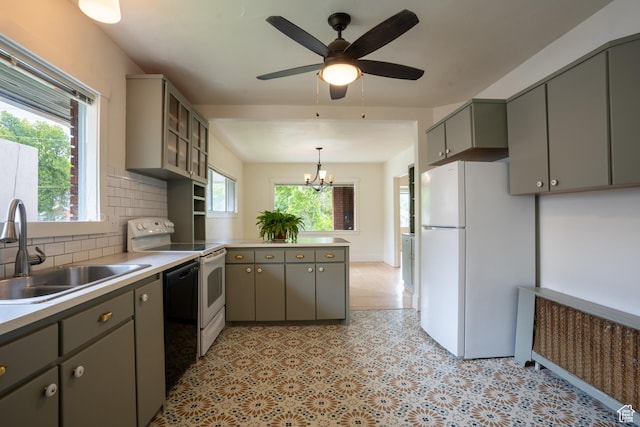 354 N 200 E, Logan, UT 84321 - kitchen featuring white appliances, gray cabinets, a sink, a peninsula, and tasteful backsplash