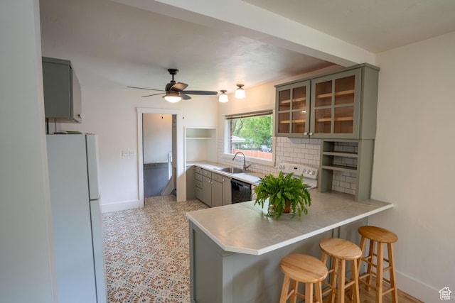 354 N 200 E, Logan, UT 84321 - kitchen with freestanding refrigerator, gray cabinets, a sink, a peninsula, and baseboards