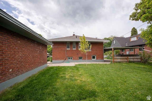 354 N 200 E, Logan, UT 84321 - back of house featuring a patio, brick siding, and a lawn
