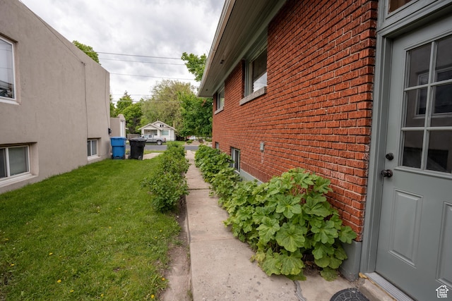 354 N 200 E, Logan, UT 84321 - view of side of home featuring brick siding and a yard