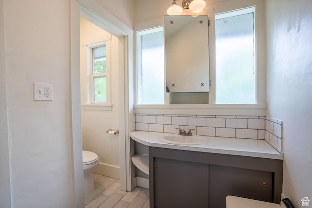354 N 200 E, Logan, UT 84321 - bathroom with toilet, vanity, and backsplash
