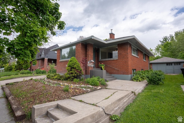 354 N 200 E, Logan, UT 84321 - view of front facade with brick siding, a chimney, and a front lawn