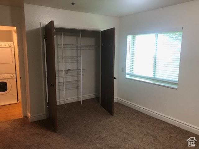 361 N 300 W Unit 107, Provo, UT 84601 - unfurnished bedroom with stacked washer / drying machine, carpet flooring, and a closet