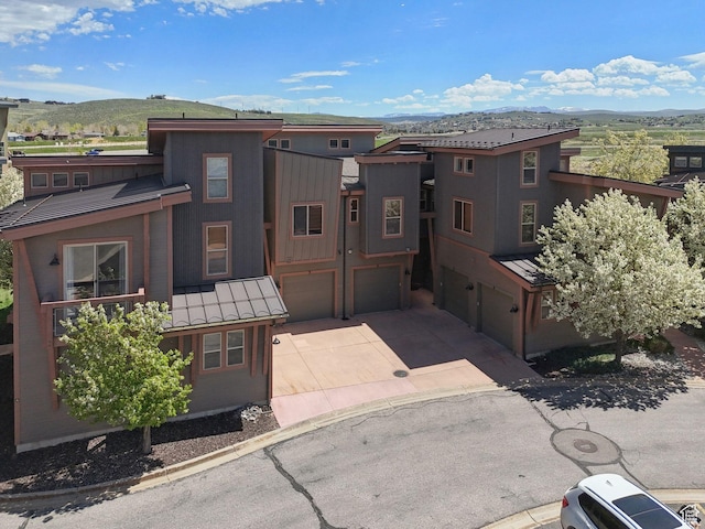 6322 N Park Ln Unit 3, Park City, UT 84098 - view of front facade with a garage, a mountain view, a standing seam roof, driveway, and metal roof