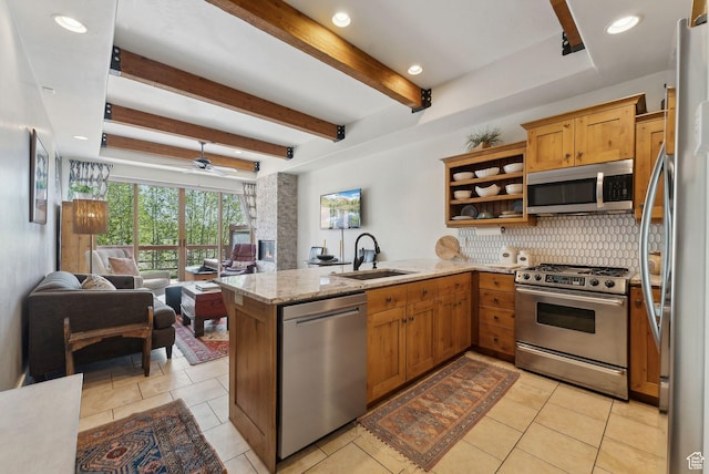 6322 N Park Ln Unit 3, Park City, UT 84098 - kitchen with stainless steel appliances, a peninsula, a sink, open floor plan, and decorative backsplash