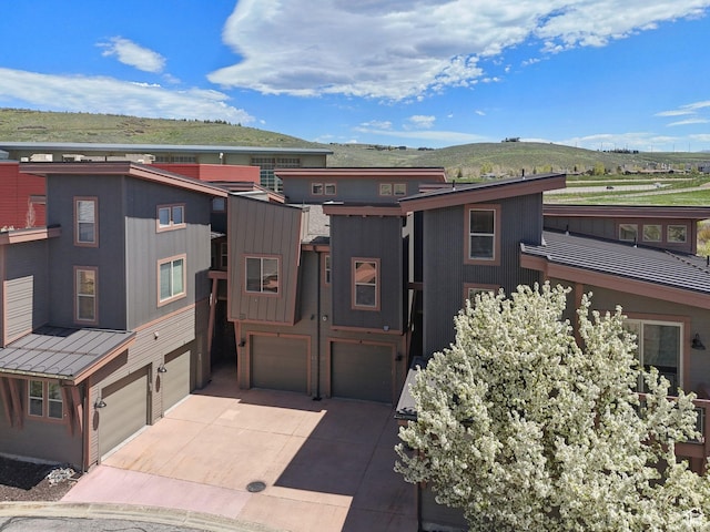 6322 N Park Ln Unit 3, Park City, UT 84098 - view of front of house featuring an attached garage, concrete driveway, and a mountain view