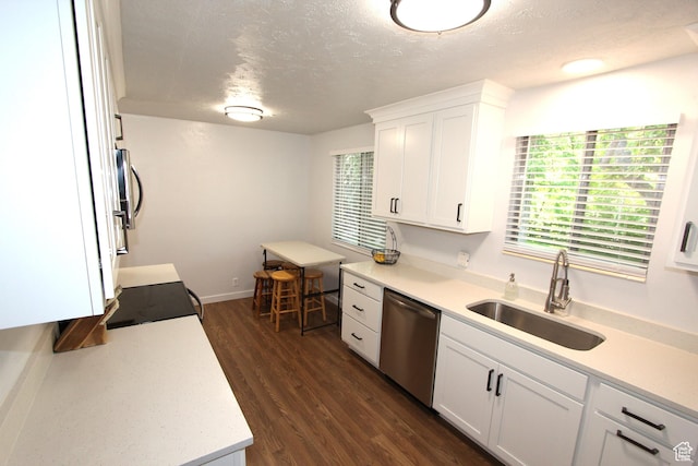 324 W 600 N, Logan, UT 84321 - kitchen featuring appliances with stainless steel finishes, a sink, a textured ceiling, light countertops, and white cabinetry