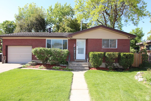324 W 600 N, Logan, UT 84321 - view of front of house featuring a garage, brick siding, driveway, and entry steps