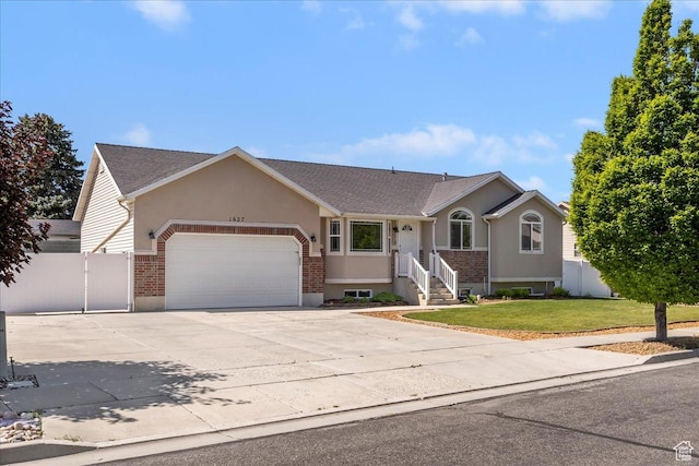 1627 W 350 N, West Point, UT 84015 - single story home featuring a garage, driveway, brick siding, roof with shingles, and stucco siding