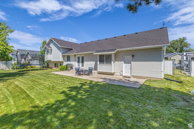 1123 N 3050 W, West Point, UT 84015 - back of property with a trampoline, a patio area, and a shingled roof