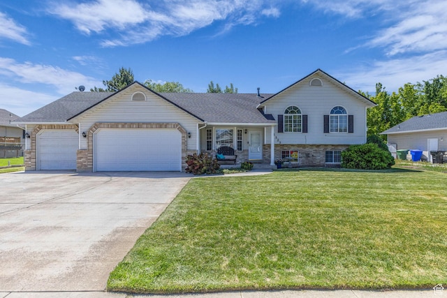 1123 N 3050 W, West Point, UT 84015 - split level home with an attached garage, concrete driveway, a front yard, roof with shingles, and a porch
