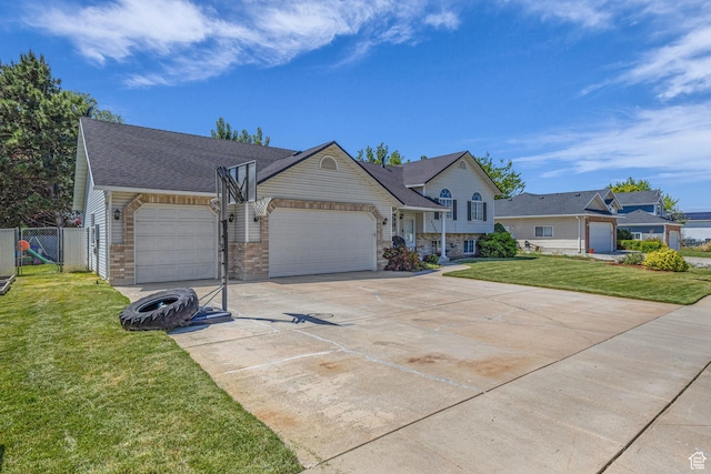 1123 N 3050 W, West Point, UT 84015 - view of front of home with an attached garage, driveway, stone siding, and roof with shingles