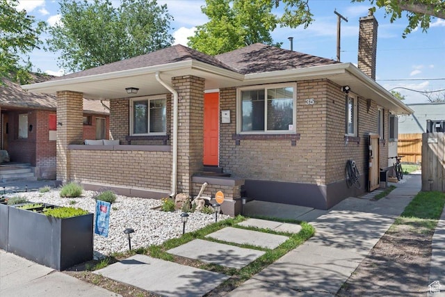 35 E Redondo Ave, Salt Lake City, UT 84115 - view of front of house featuring a chimney, brick siding, and roof with shingles