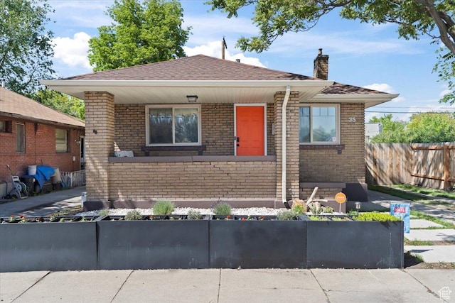 35 E Redondo Ave, Salt Lake City, UT 84115 - bungalow-style home with a chimney, brick siding, and a shingled roof
