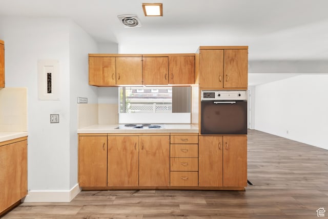 3616 S 860 E Unit 72, Salt Lake City, UT 84106 - kitchen with stainless steel oven, light wood-type flooring, white electric stovetop, and electric panel