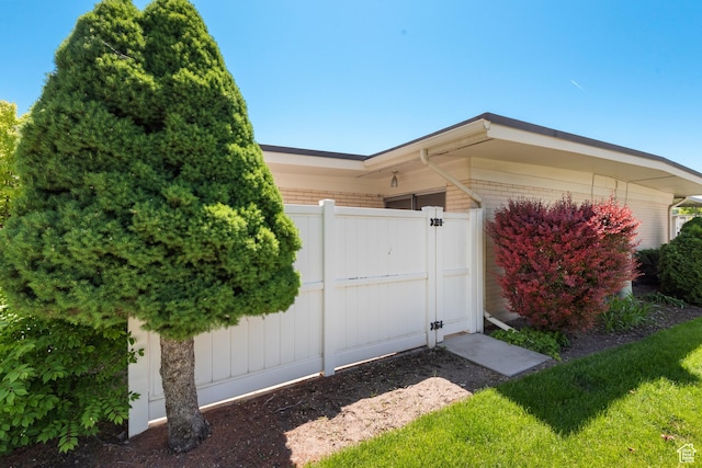 3616 S 860 E Unit 72, Salt Lake City, UT 84106 - property entrance with a gate, brick siding, and a garage