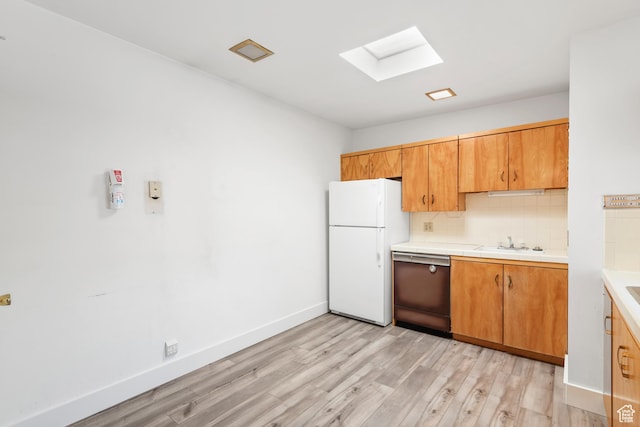 3616 S 860 E Unit 72, Salt Lake City, UT 84106 - kitchen with freestanding refrigerator, dishwashing machine, a skylight, tasteful backsplash, and light wood finished floors
