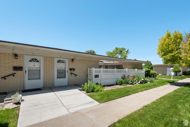 3616 S 860 E Unit 72, Salt Lake City, UT 84106 - view of front facade featuring brick siding and a front yard