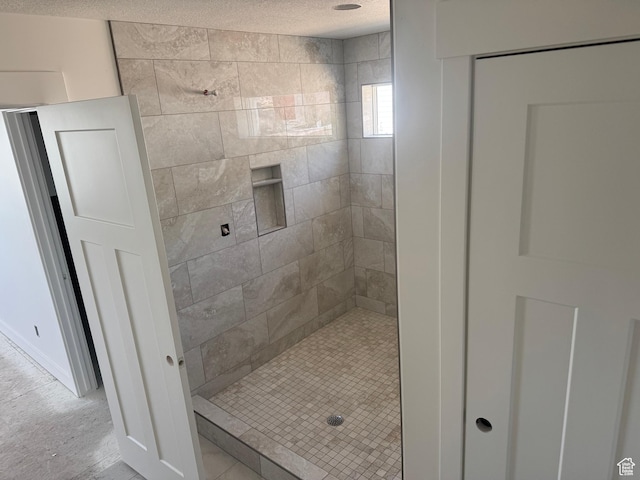 3023 N Mountain Rd E Unit 212, North Ogden, UT 84414 - full bath featuring a tile shower and a textured ceiling