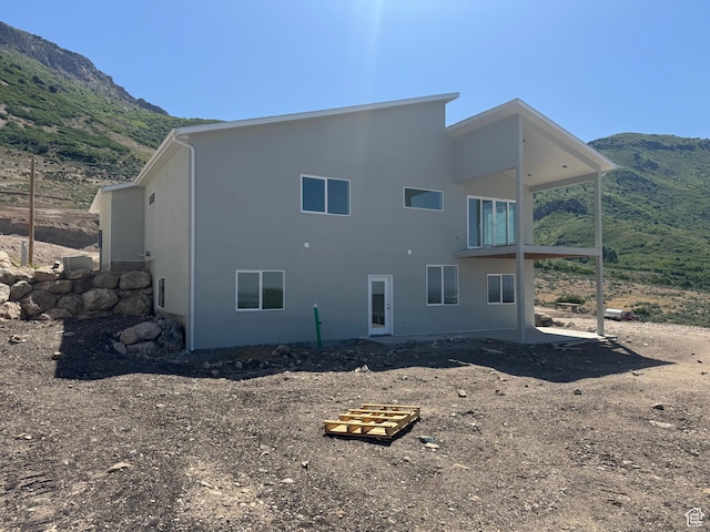 3023 N Mountain Rd E Unit 212, North Ogden, UT 84414 - rear view of house featuring a mountain view and stucco siding