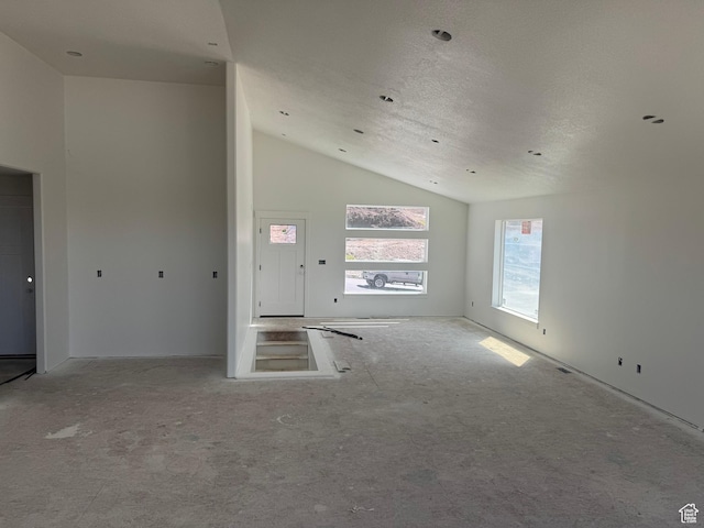 3023 N Mountain Rd E Unit 212, North Ogden, UT 84414 - carpeted spare room with vaulted ceiling and a textured ceiling