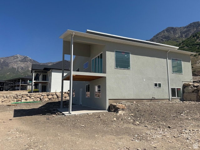 3023 N Mountain Rd E Unit 212, North Ogden, UT 84414 - back of house with a mountain view and stucco siding