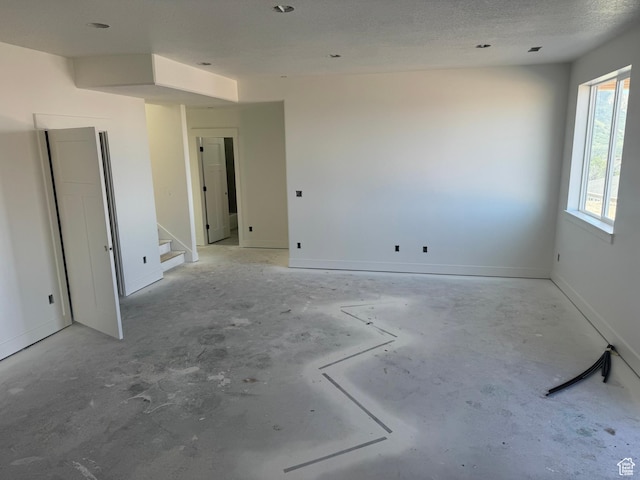 3023 N Mountain Rd E Unit 212, North Ogden, UT 84414 - empty room featuring stairs and unfinished concrete flooring