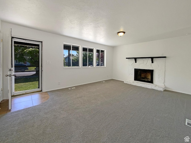5644 S Treebeard Rd, Taylorsville, UT 84129 - unfurnished living room featuring plenty of natural light, a fireplace, carpet flooring, and baseboards