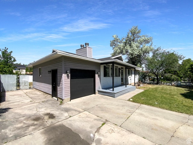 5644 S Treebeard Rd, Taylorsville, UT 84129 - view of front facade with an attached garage, concrete driveway, and a chimney