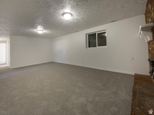 5644 S Treebeard Rd, Taylorsville, UT 84129 - unfurnished living room featuring a textured ceiling, dark colored carpet, baseboards, and a fireplace