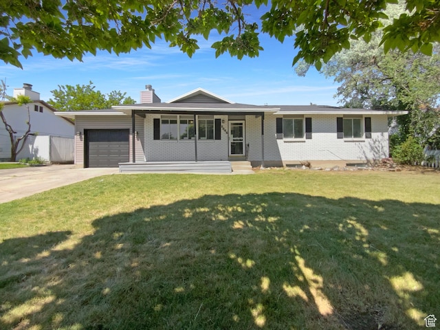 5644 S Treebeard Rd, Taylorsville, UT 84129 - single story home featuring a garage, driveway, a chimney, brick siding, and a front lawn