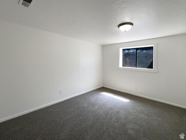 5644 S Treebeard Rd, Taylorsville, UT 84129 - spare room featuring dark colored carpet and baseboards