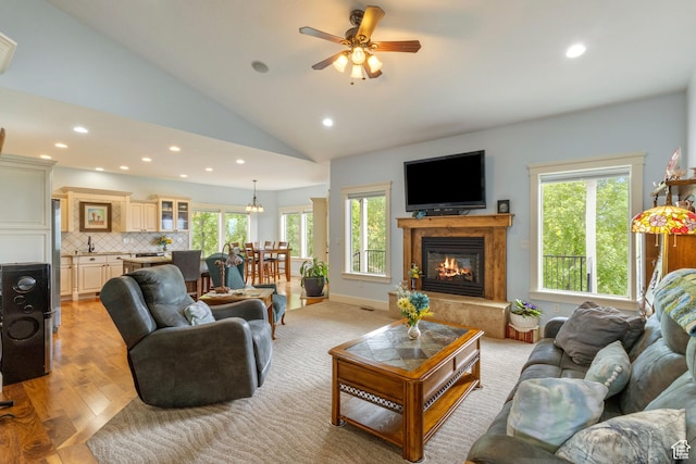 2078 E 3025 N, North Logan, UT 84341 - living area with recessed lighting, plenty of natural light, a glass covered fireplace, vaulted ceiling, and a ceiling fan