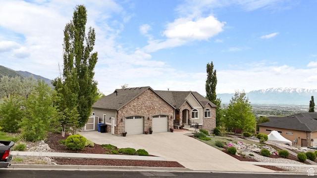 2078 E 3025 N, North Logan, UT 84341 - french country inspired facade featuring stone siding, an attached garage, concrete driveway, and a mountain view