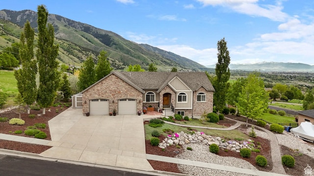 2078 E 3025 N, North Logan, UT 84341 - view of front of property with stone siding, a garage, a mountain view, and concrete driveway
