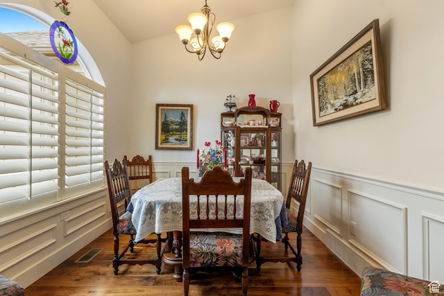 2078 E 3025 N, North Logan, UT 84341 - dining space with a chandelier, a decorative wall, wood finished floors, a wainscoted wall, and lofted ceiling