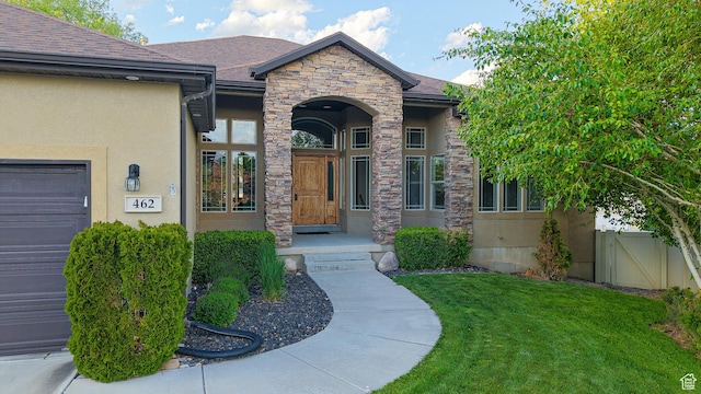 462 W Rosemary Pl, Saratoga Springs, UT 84045 - property entrance featuring stone siding, stucco siding, a gate, and a shingled roof