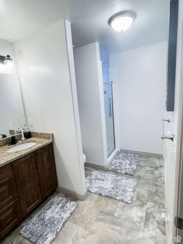 1303 N 150 E, Nephi, UT 84648 - full bath with a textured ceiling, vanity, a shower stall, toilet, and baseboards