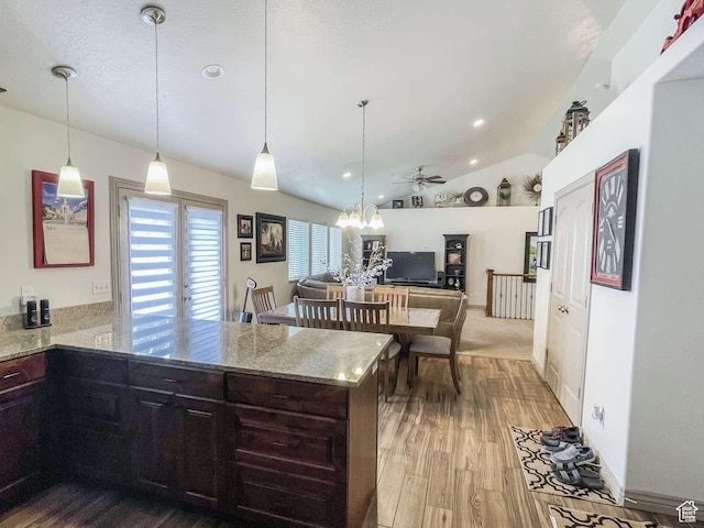 1303 N 150 E, Nephi, UT 84648 - kitchen with vaulted ceiling, a peninsula, light stone countertops, wood finished floors, and ceiling fan