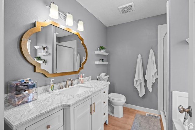 524 N 2870 W, Provo, UT 84601 - bathroom featuring an enclosed shower, vanity, wood finished floors, toilet, and baseboards