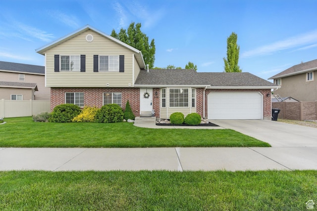 524 N 2870 W, Provo, UT 84601 - tri-level home with brick siding, a garage, driveway, and roof with shingles