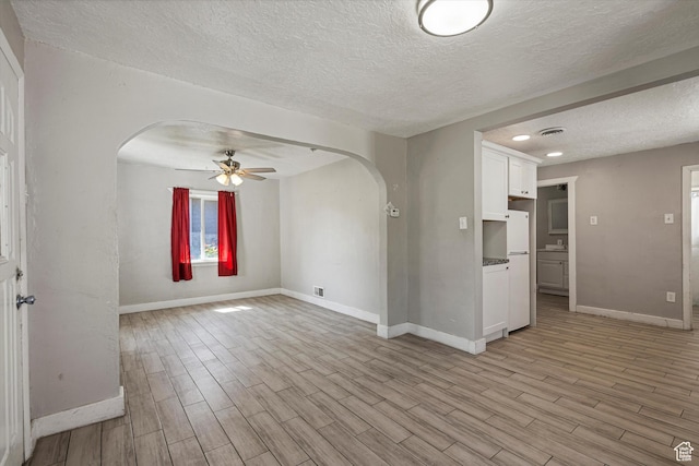 254 Franklin St, Ogden, UT 84401 - empty room with arched walkways, a textured ceiling, ceiling fan, light wood-style floors, and recessed lighting